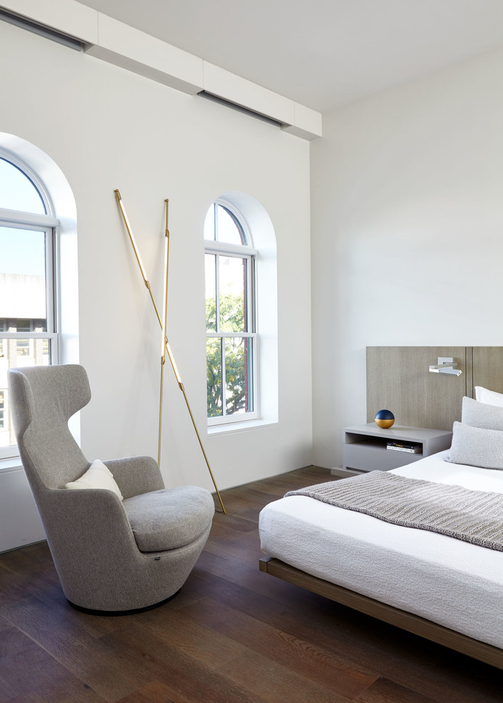 Mittelgroßes Modernes Hauptschlafzimmer mit weißer Wandfarbe, braunem Boden und dunklem Holzboden in New York