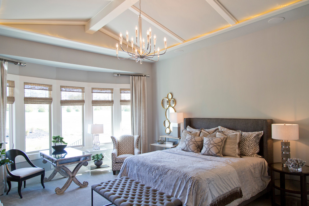 This is an example of a large traditional master bedroom in Kansas City with grey walls and carpet.