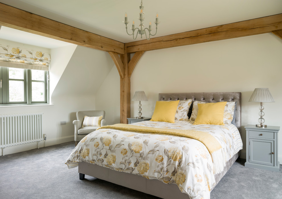 Farmhouse bedroom in West Midlands with white walls, carpet and grey floors.