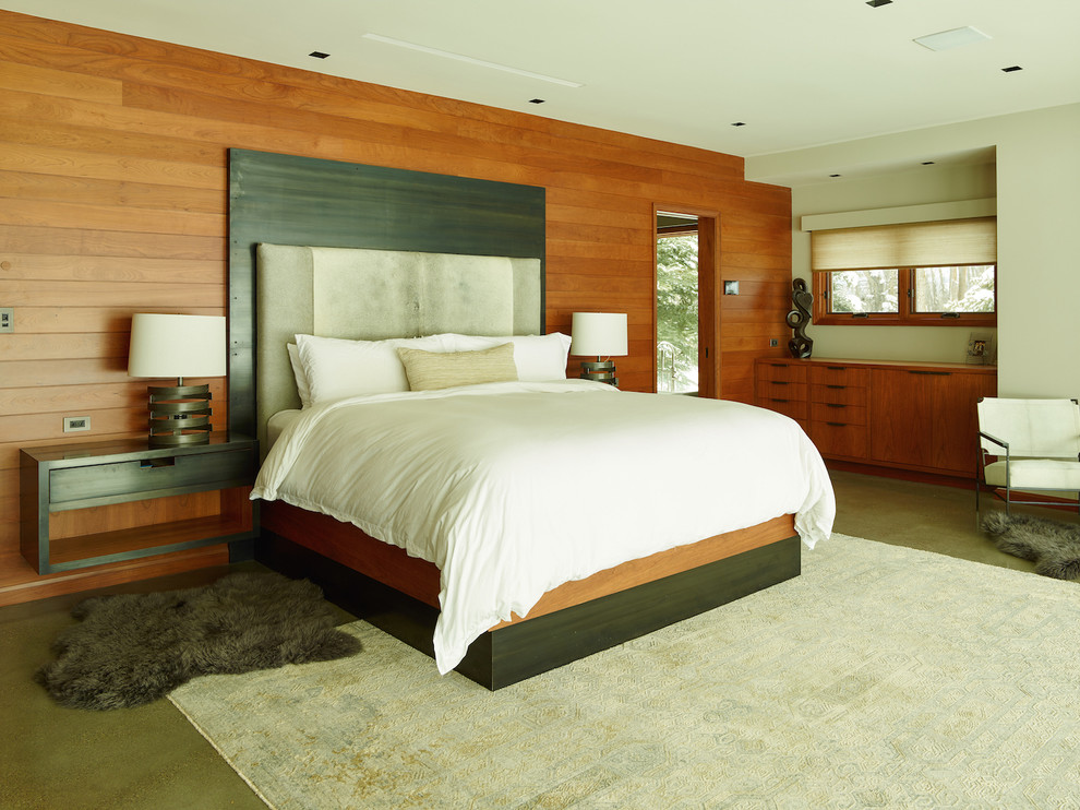 Photo of an expansive eclectic master bedroom in Portland with white walls and concrete flooring.