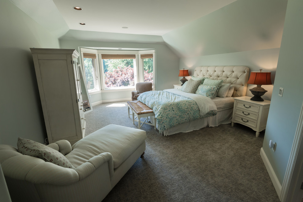 This is an example of a large traditional master bedroom in Portland with blue walls, carpet and beige floors.