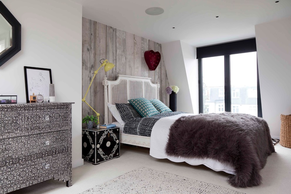 Medium sized bohemian bedroom in London with white walls, carpet and white floors.