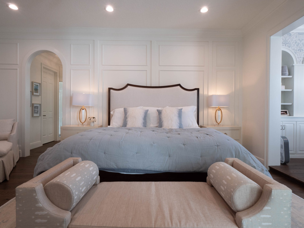 Klassisches Hauptschlafzimmer mit weißer Wandfarbe, braunem Holzboden, braunem Boden und vertäfelten Wänden in Orlando