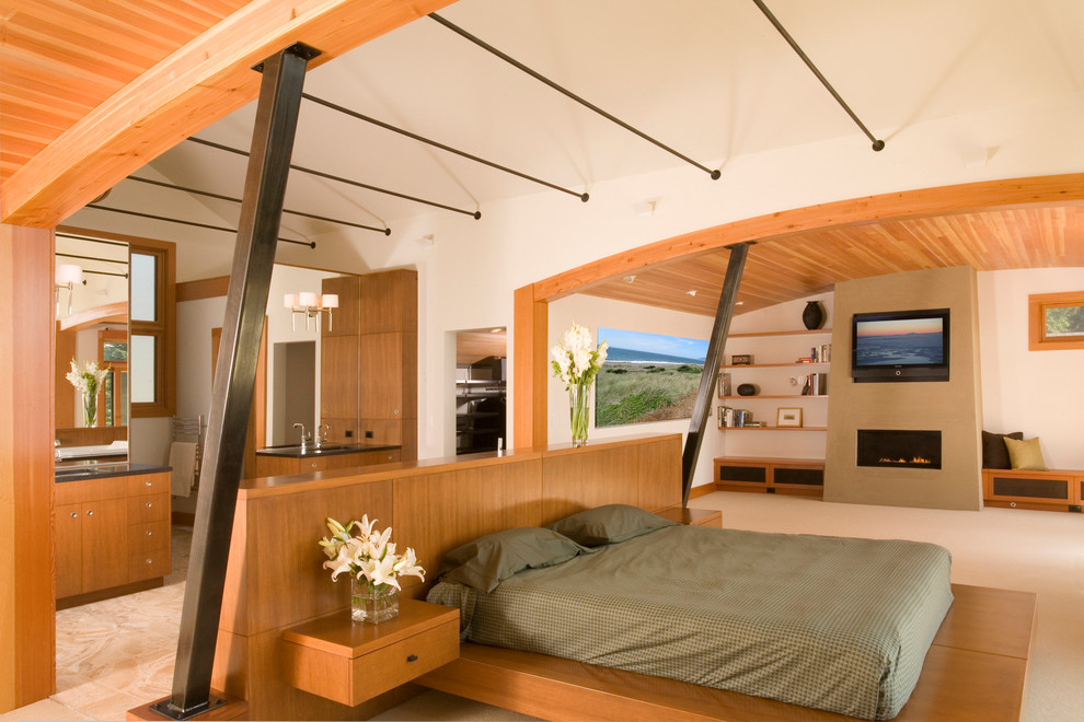 This is an example of a contemporary bedroom in Seattle with a ribbon fireplace.