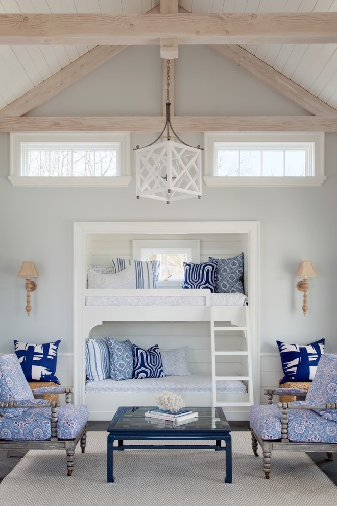 Photo of a beach style guest bedroom in Other with grey walls.