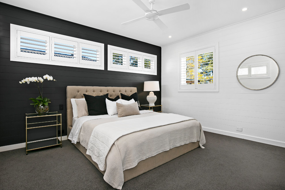 Bild på ett maritimt sovrum, med svarta väggar, heltäckningsmatta och grått golv