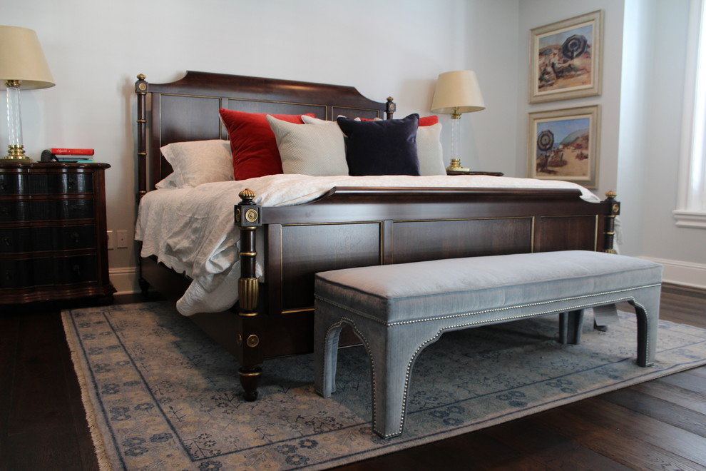 Small elegant master medium tone wood floor bedroom photo in Orlando with gray walls