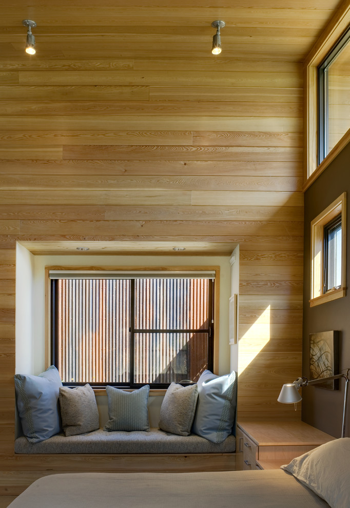 Immagine di una camera da letto design con pareti marroni