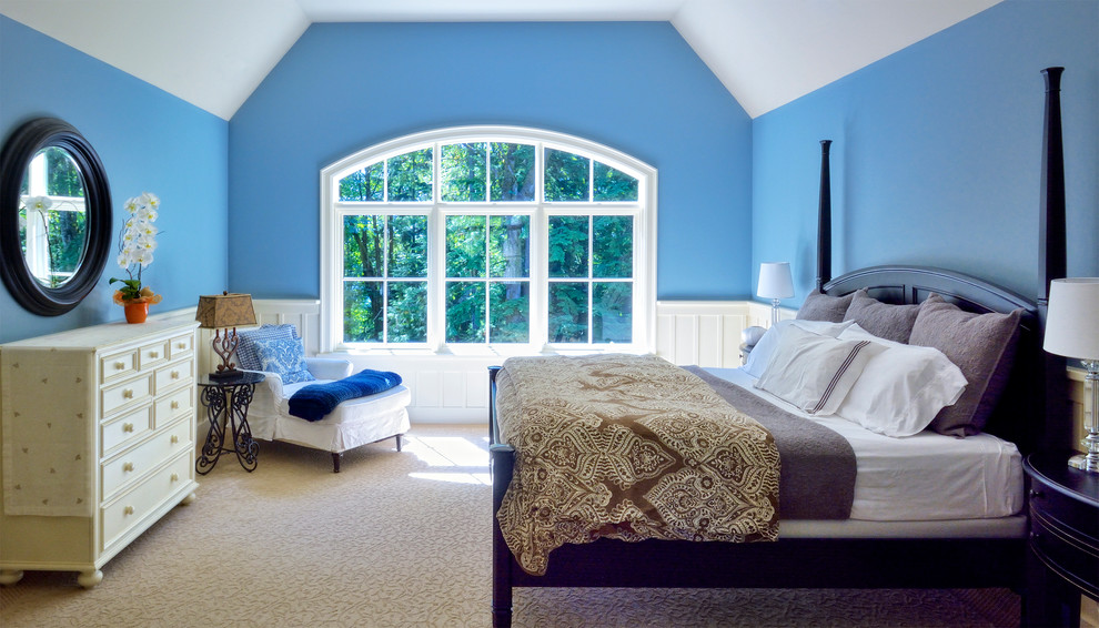 This is an example of a large classic master bedroom in Seattle with blue walls, carpet and no fireplace.