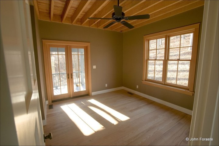 Photo of a medium sized classic guest bedroom in Other with brown walls and light hardwood flooring.