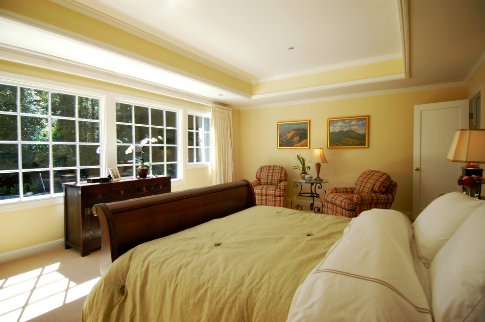 Imagen de dormitorio principal tradicional renovado grande con paredes amarillas y suelo de baldosas de cerámica