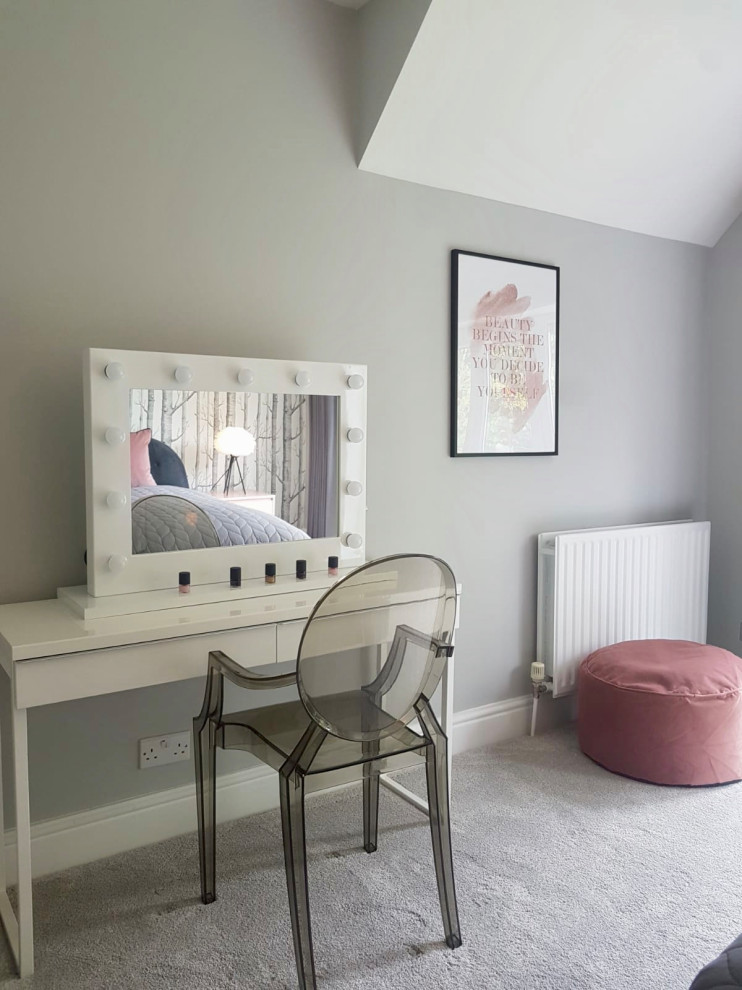 This is an example of a large scandi guest and grey and pink bedroom in Hertfordshire with grey walls, carpet and grey floors.