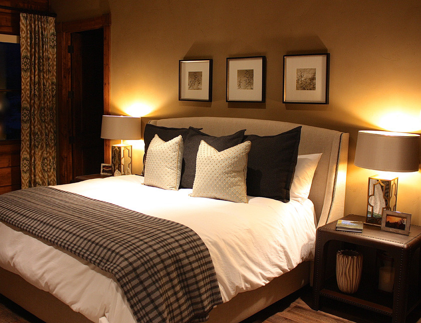 Large elegant guest medium tone wood floor bedroom photo in Austin with yellow walls