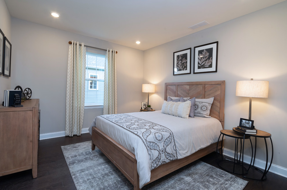 Example of a mid-sized cottage guest medium tone wood floor and brown floor bedroom design in Philadelphia with gray walls