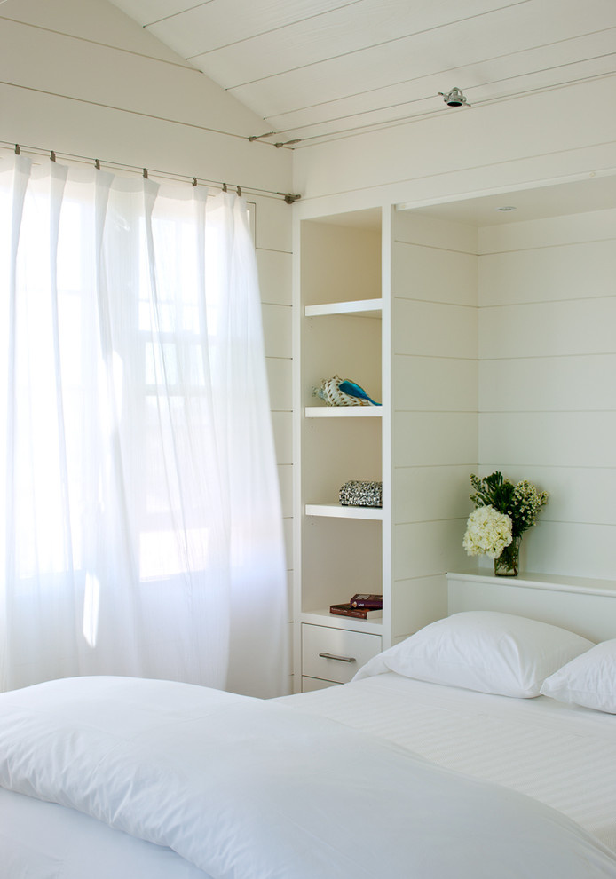 Bedroom - small coastal guest light wood floor bedroom idea in Boston with white walls