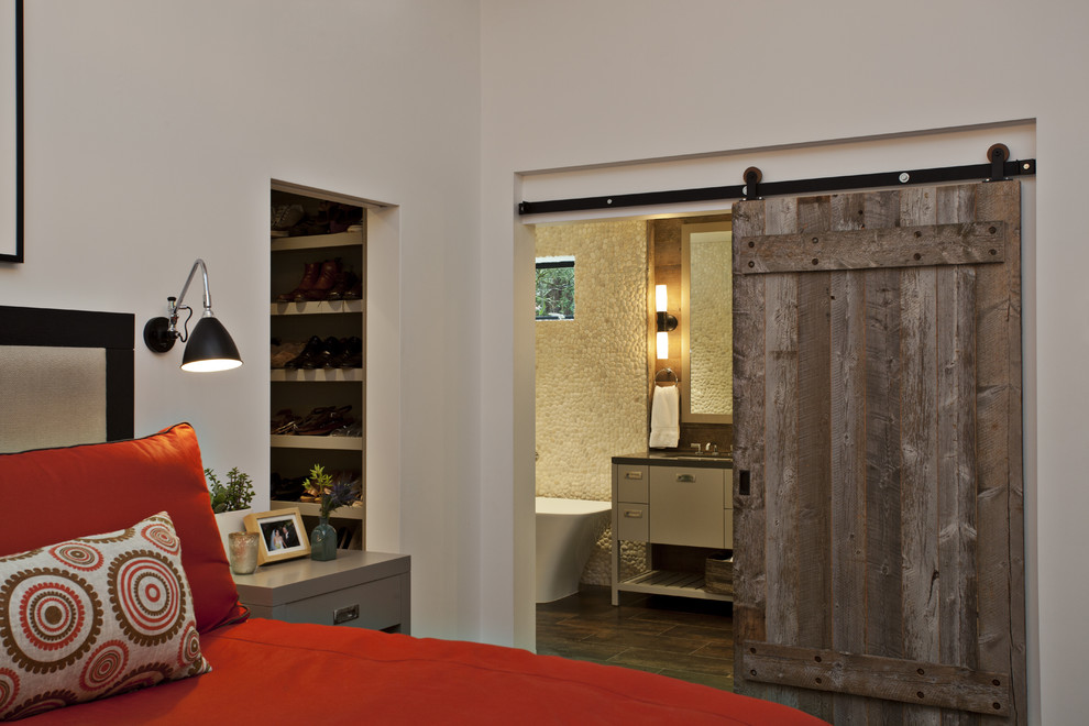 Inspiration for a large contemporary dark wood floor bedroom remodel in San Francisco with white walls
