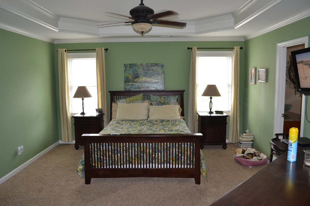 Photo of a traditional master bedroom in Atlanta with green walls and carpet.