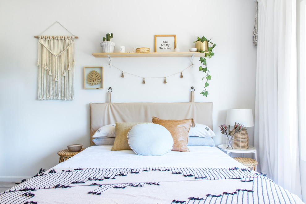 Example of a beach style bedroom design in Wollongong with white walls