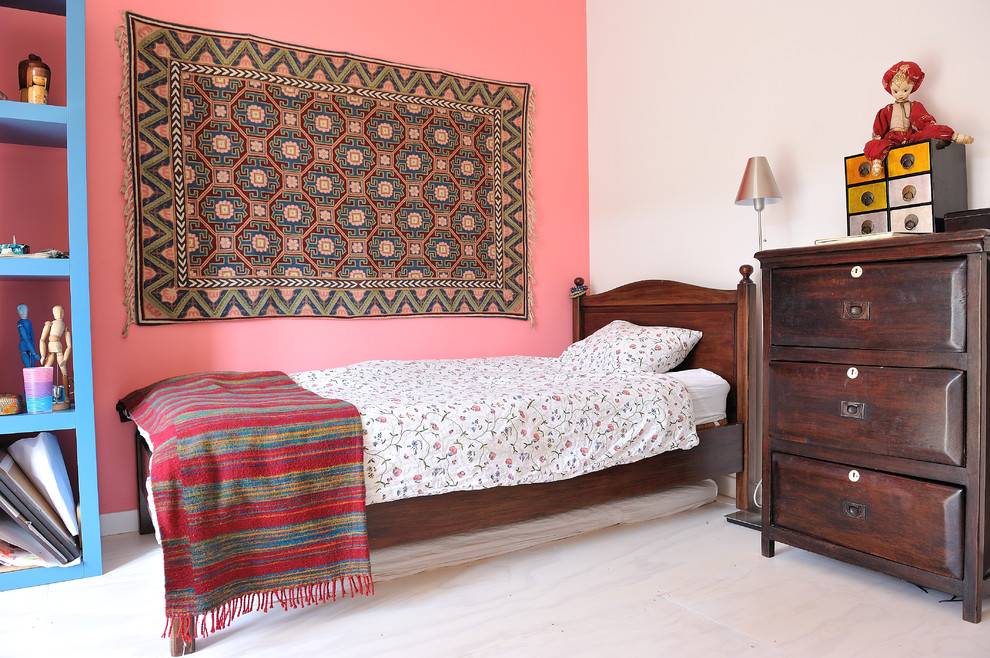 Example of an eclectic bedroom design in Amsterdam with pink walls