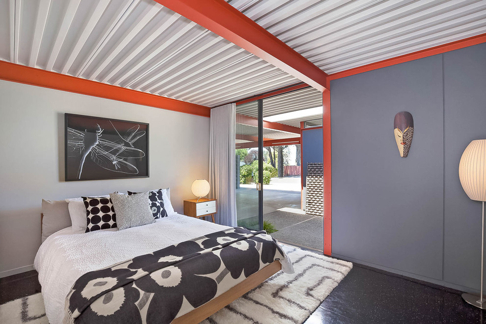 Immagine di una camera da letto moderna con pareti grigie e pavimento nero