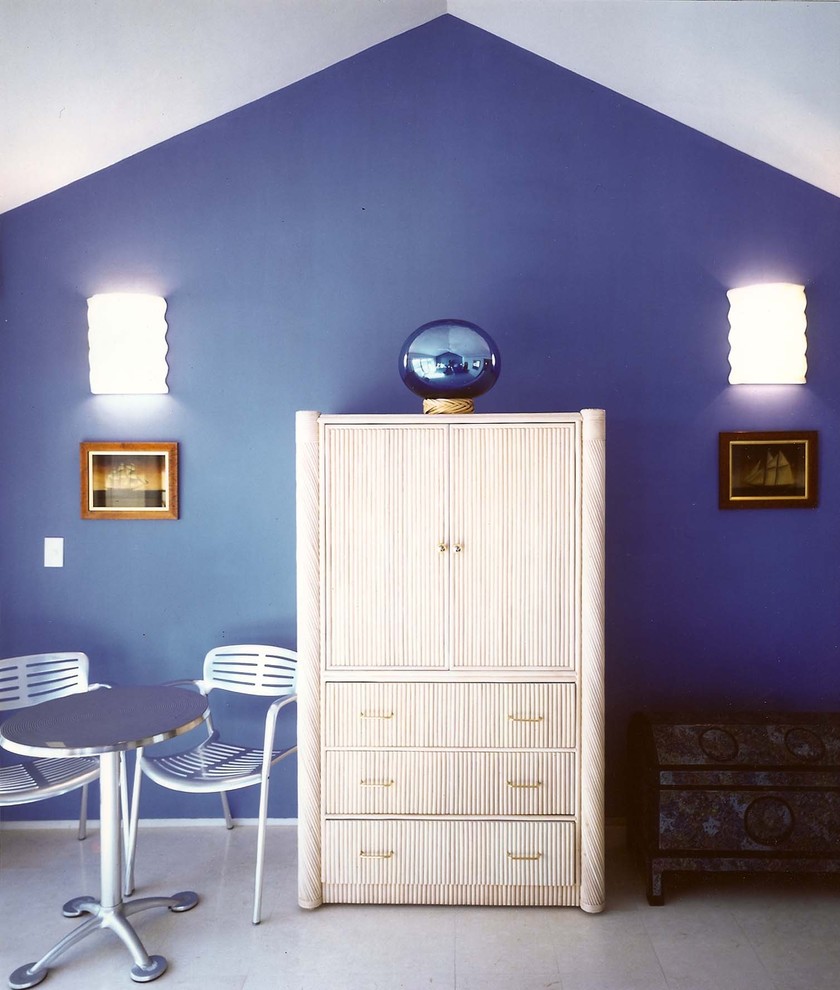Example of an island style bedroom design in Other with blue walls