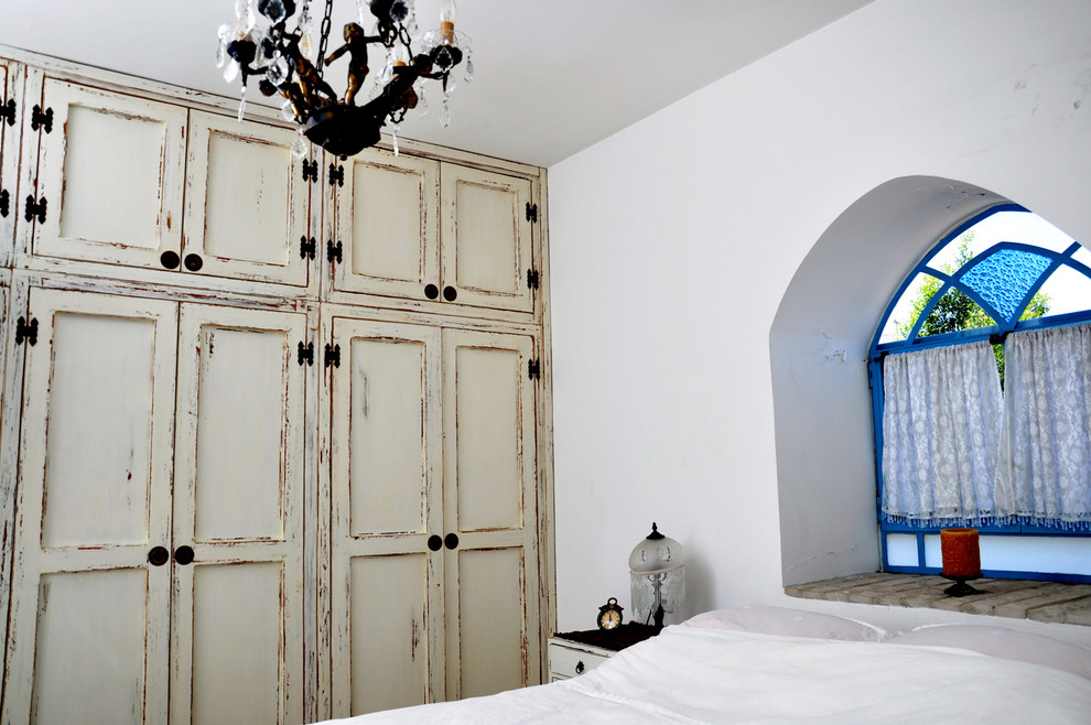 Inspiration for a mediterranean bedroom in Tel Aviv with white walls.
