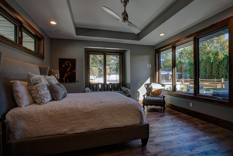 This is an example of a large classic master bedroom in Other with grey walls and medium hardwood flooring.