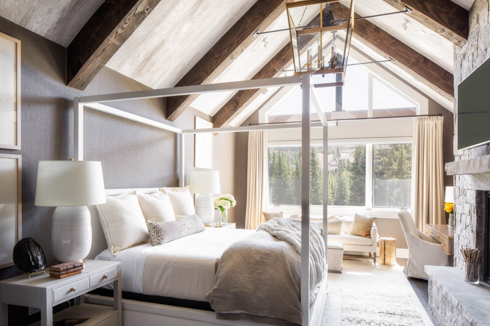Inspiration for a rustic master bedroom remodel in Other with gray walls, a standard fireplace and a stone fireplace