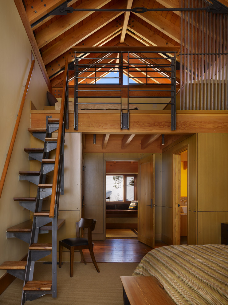 Large urban loft-style carpeted and beige floor bedroom photo in Seattle with beige walls and no fireplace