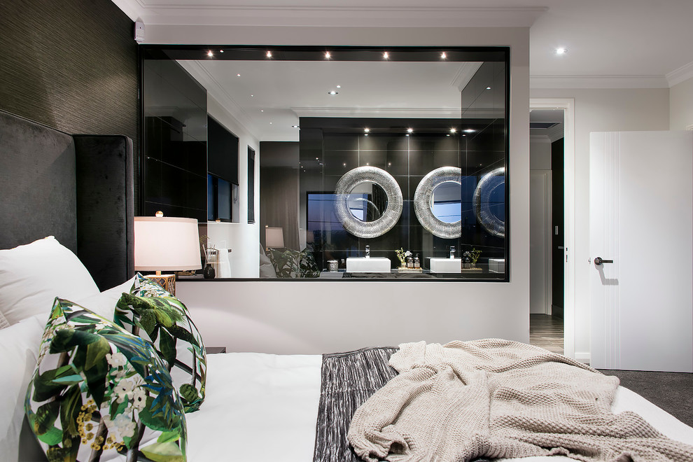 Cette image montre une grande chambre minimaliste avec un mur blanc et un sol gris.