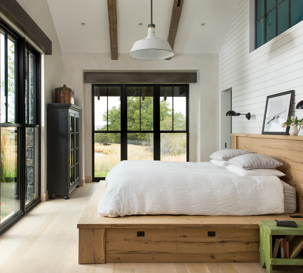Design ideas for a rural guest bedroom in Other with white walls, light hardwood flooring, beige floors and no fireplace.
