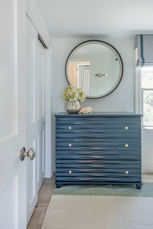 Example of a large beach style master light wood floor and beige floor bedroom design in Boston with gray walls and no fireplace