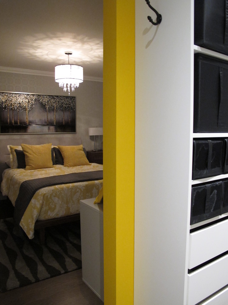 Photo of a large contemporary master bedroom in Montreal with yellow walls, dark hardwood flooring and brown floors.