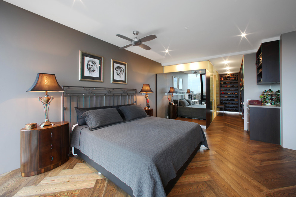 Photo of a modern grey and brown bedroom in Melbourne with grey walls, medium hardwood flooring and brown floors.