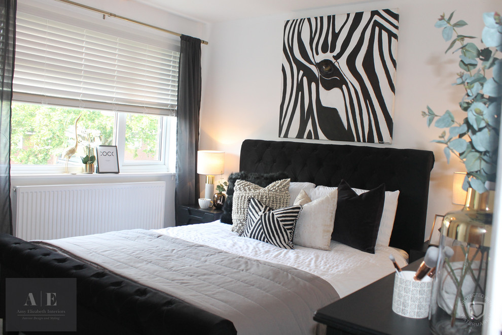 This is an example of a small eclectic master bedroom in Hampshire with white walls, carpet and grey floors.