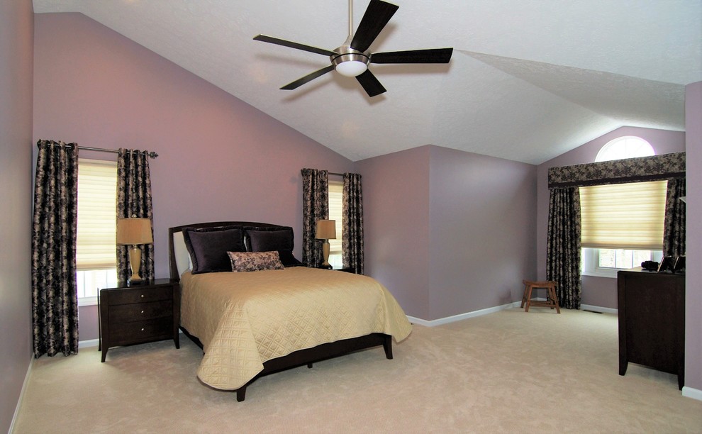 Photo of a large traditional master bedroom in Philadelphia with purple walls, carpet, a standard fireplace, a wooden fireplace surround and beige floors.