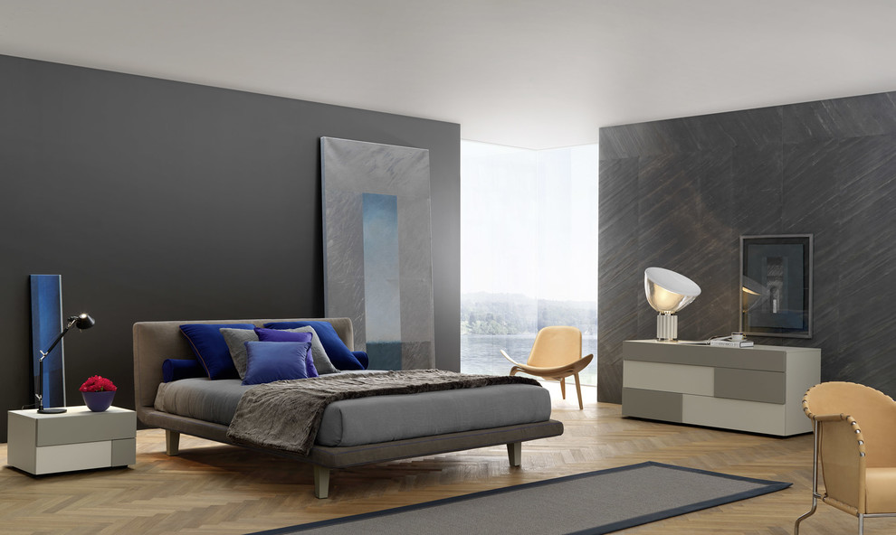 Design ideas for a modern bedroom in New York with grey walls and medium hardwood flooring.