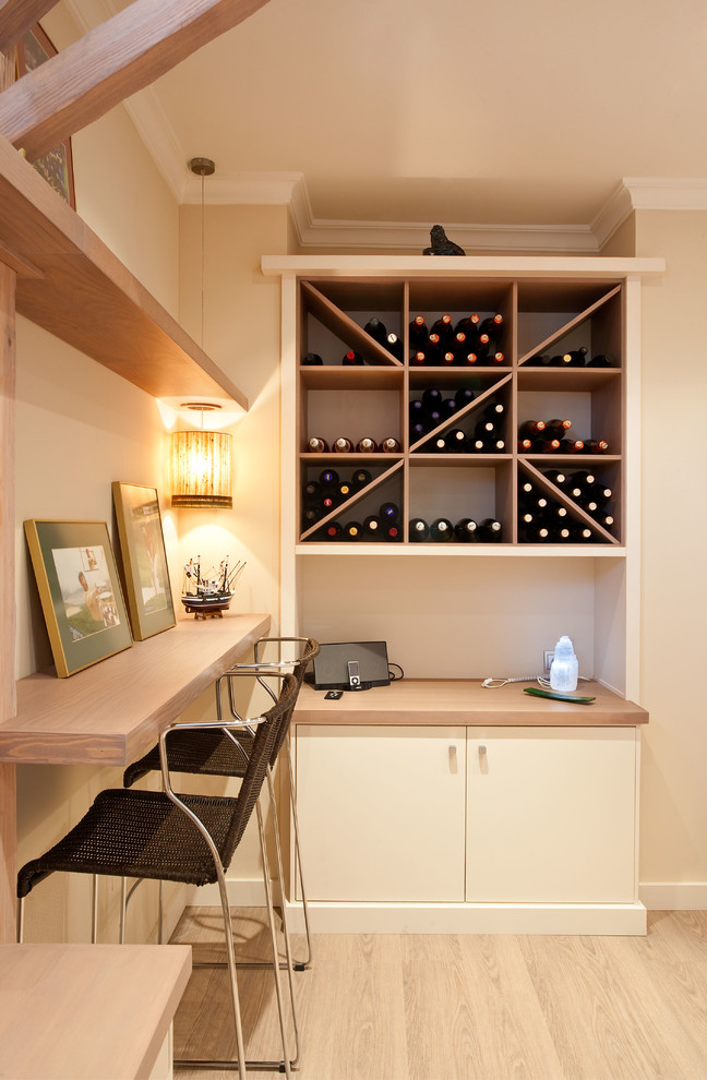 Inspiration for a mediterranean light wood floor and beige floor wine cellar remodel in Seville with diamond bins