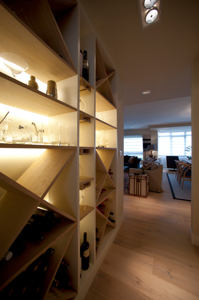 Wine cellar - small transitional light wood floor and beige floor wine cellar idea in Bilbao with diamond bins