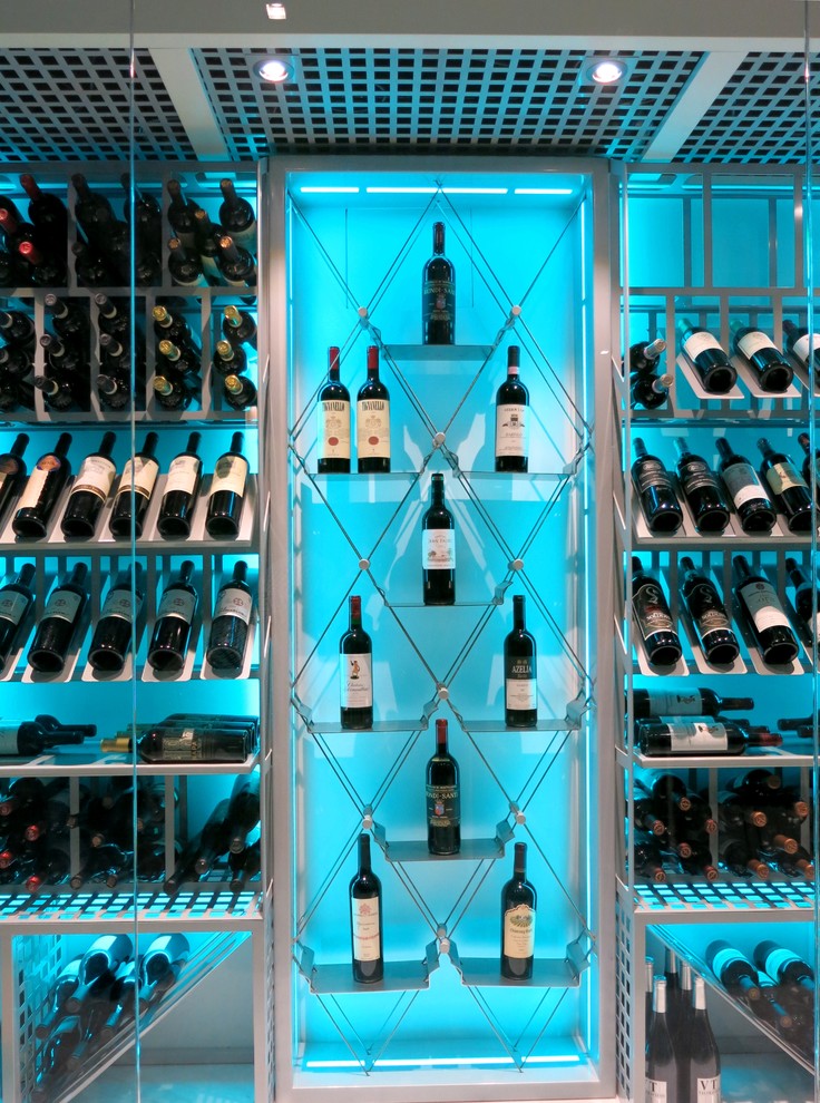 This is an example of a medium sized contemporary wine cellar in Miami with porcelain flooring, display racks and grey floors.