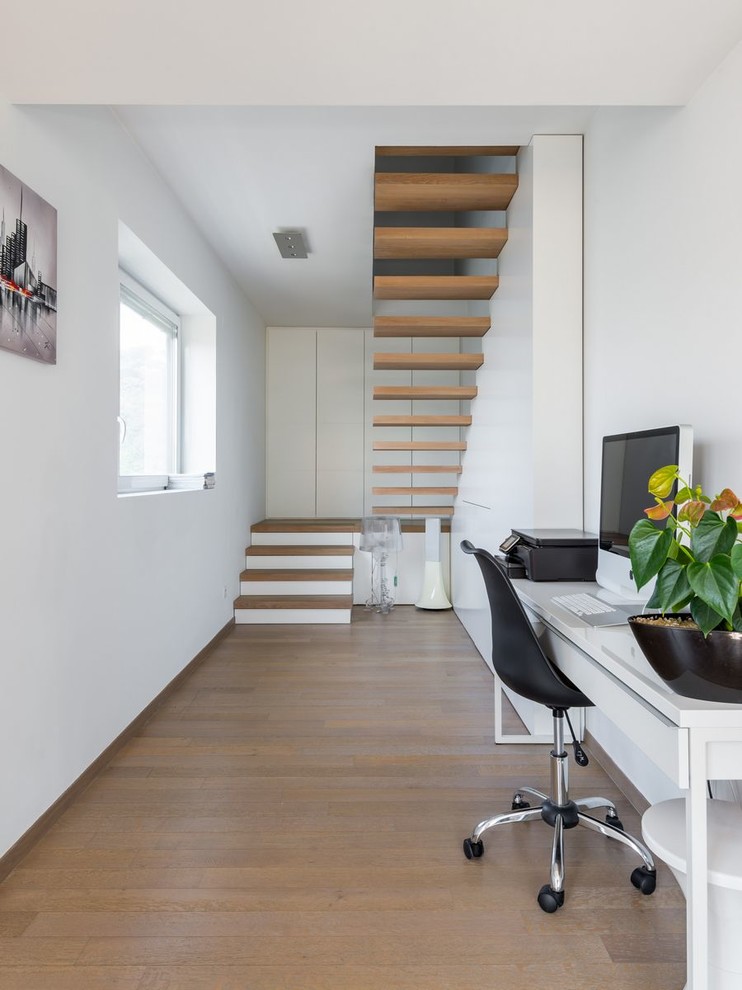 Study room - mid-sized scandinavian freestanding desk medium tone wood floor study room idea in Lyon with white walls