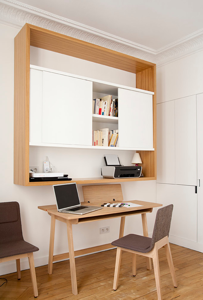 Идея дизайна: рабочее место в современном стиле с белыми стенами, паркетным полом среднего тона и отдельно стоящим рабочим столом