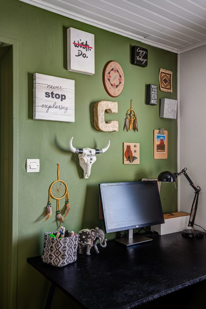 Imagen de despacho actual pequeño sin chimenea con biblioteca, paredes verdes, suelo laminado, escritorio independiente y suelo blanco