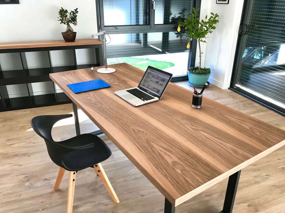 Example of a large transitional freestanding desk light wood floor and beige floor study room design in Lyon with white walls and no fireplace