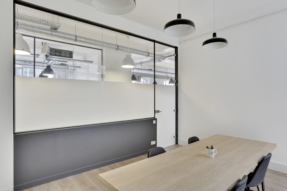 Cette photo montre un bureau tendance de taille moyenne avec un mur blanc, parquet clair, un bureau indépendant et un sol blanc.