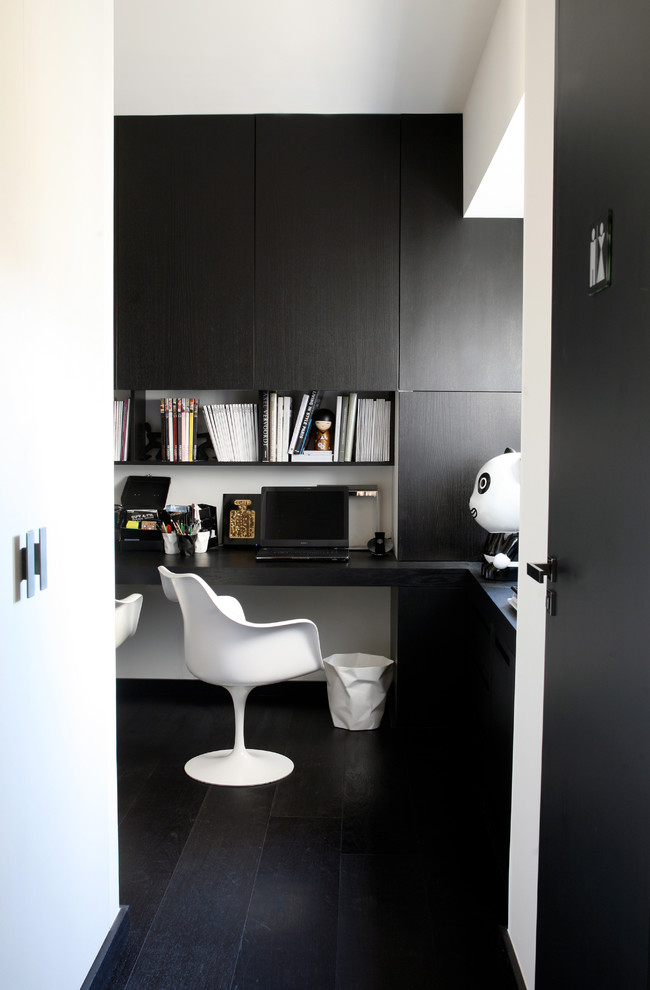 Aménagement d'un petit bureau avec un mur noir, parquet foncé, aucune cheminée, un bureau indépendant et un sol noir.