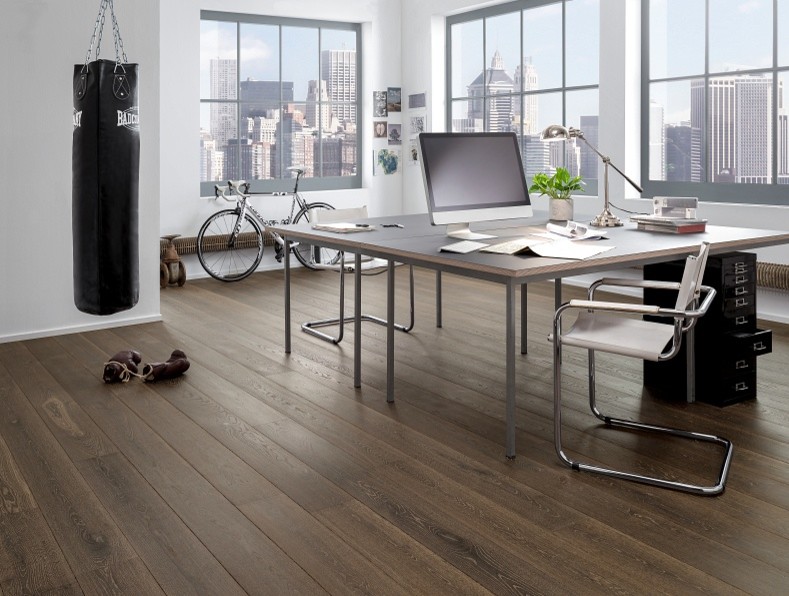 Medium sized contemporary study in New York with dark hardwood flooring, a freestanding desk and black floors.