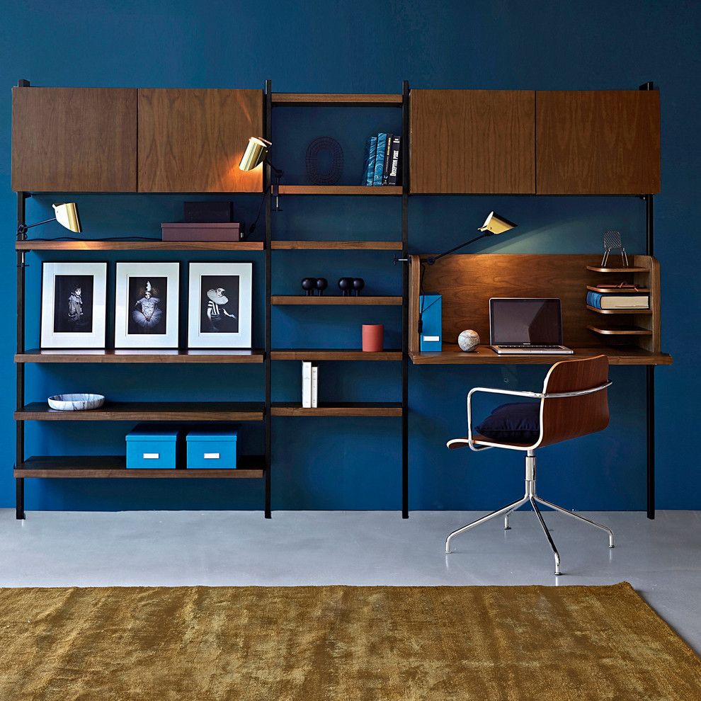 На фото: рабочее место среднего размера в стиле ретро с синими стенами, бетонным полом и встроенным рабочим столом без камина