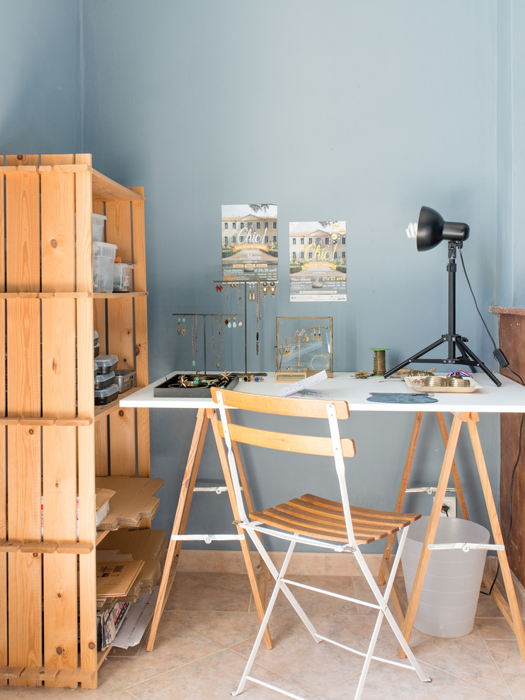 Foto de sala de manualidades campestre con paredes azules, escritorio independiente y suelo rosa