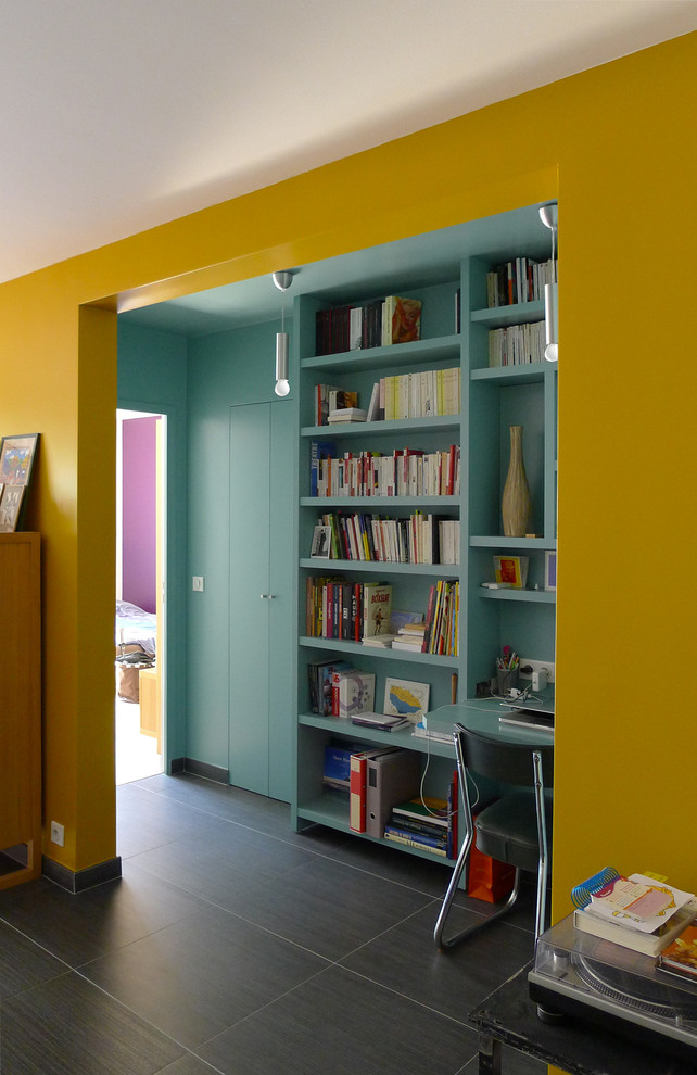 Exempel på ett litet retro hemmabibliotek, med blå väggar, klinkergolv i keramik och ett inbyggt skrivbord